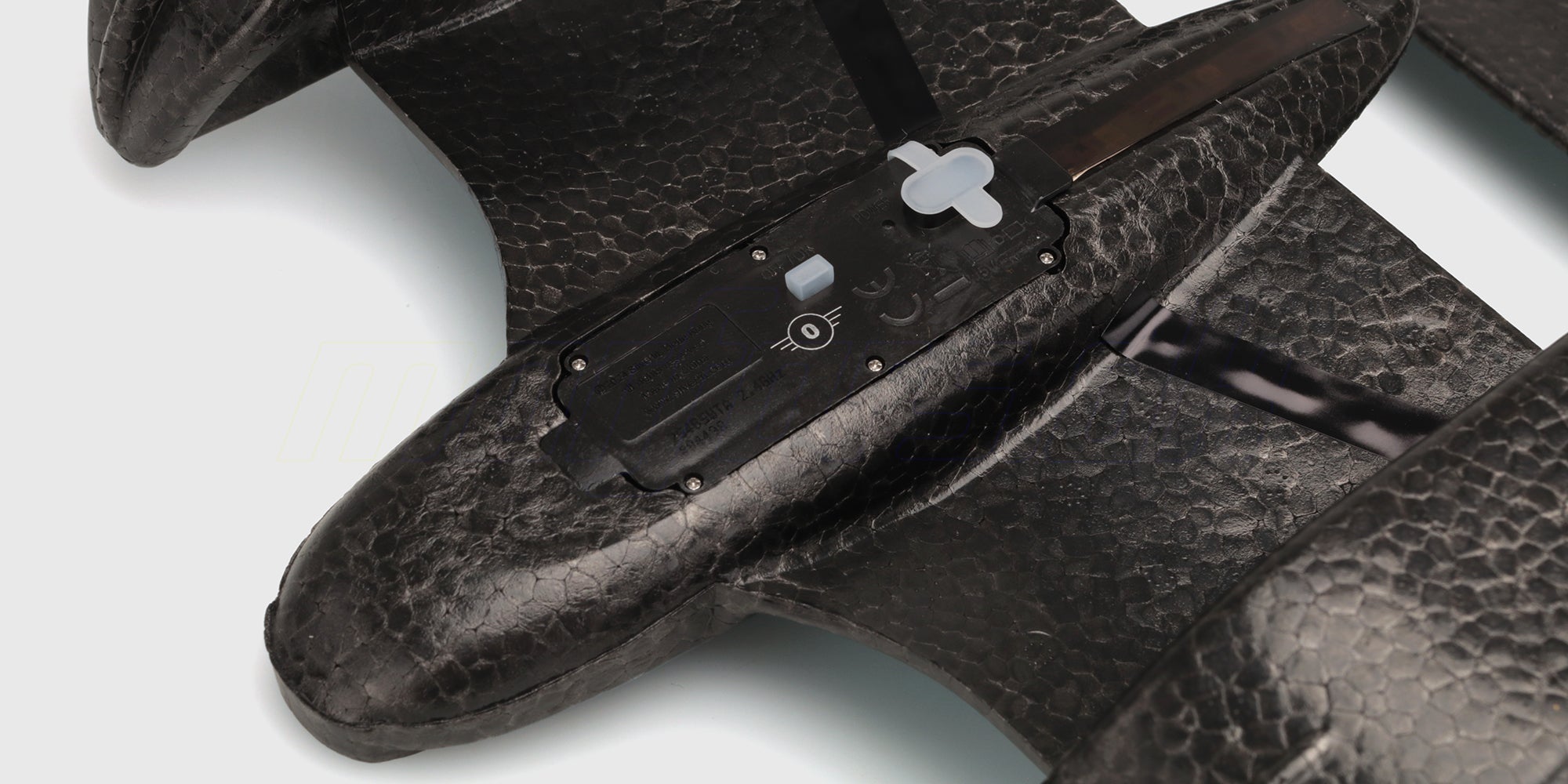 Tændknap og ladeport på undersiden af Aqua Wingz
