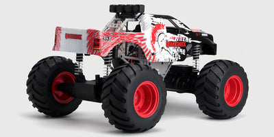 Sort Quakeshock fjernstyret monster truck med store offroad-hjul og robust karrosseri vist på hvid baggrund.